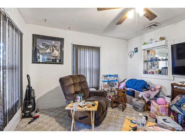 a living room with furniture a rug and a window