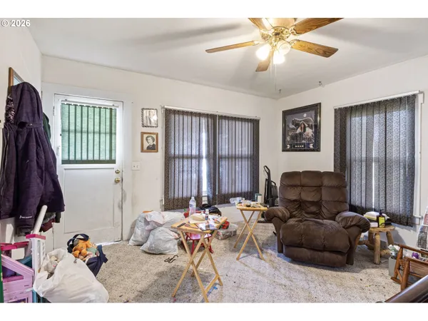 a living room with furniture a window and a chandelier