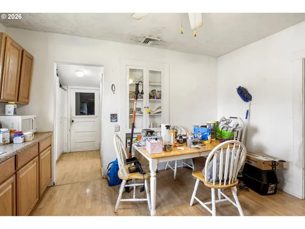 a dining room with furniture and wooden floor