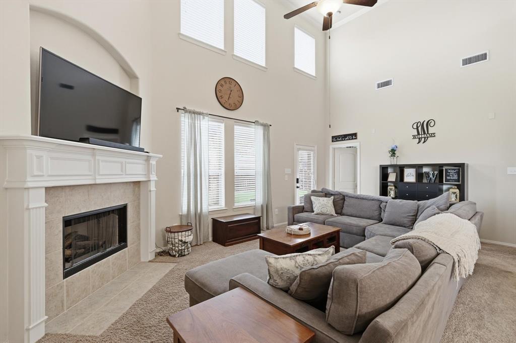 7105 Edwards Road Denton, TX 76208 - Photo 11 of 40 Open living area with soaring ceilings, fireplace, and abundant natural light.