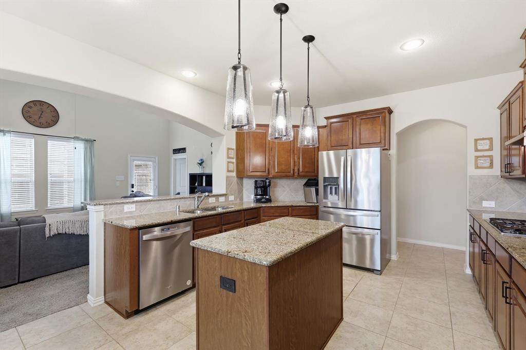 7105 Edwards Road Denton, TX 76208 - Photo 16 of 40 Functional kitchen layout open to the living area, ideal for entertaining.