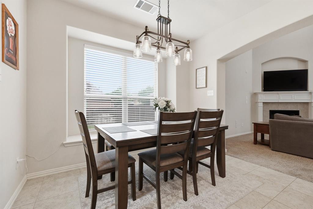 7105 Edwards Road Denton, TX 76208 - Photo 17 of 40 Breakfast area with large window and open flow to the living room.