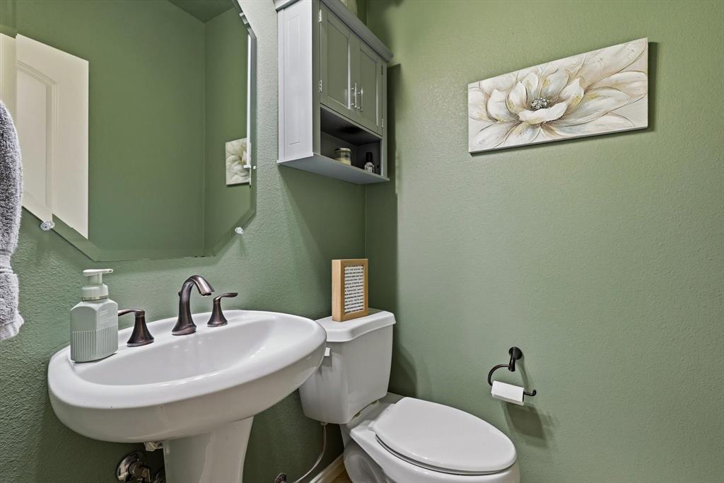 7105 Edwards Road Denton, TX 76208 - Photo 18 of 40 Convenient half bath with pedestal sink.