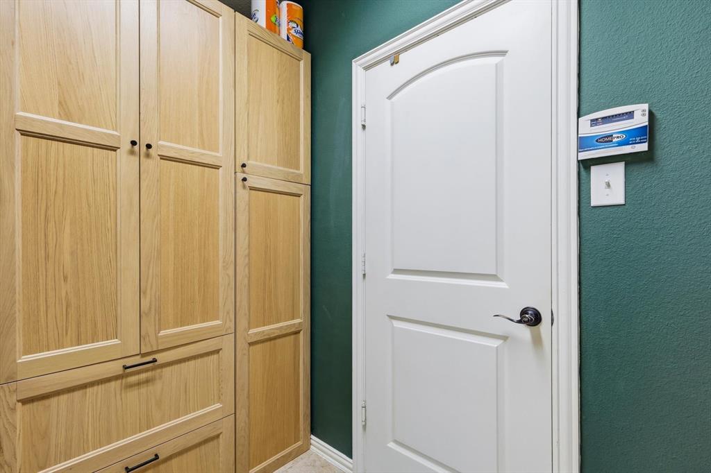 7105 Edwards Road Denton, TX 76208 - Photo 20 of 40 Functional laundry space with custom cabinets for pantry and storage.
