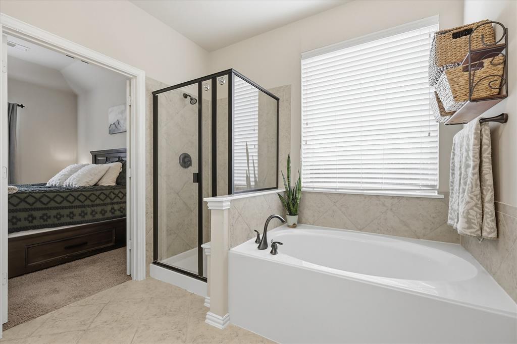7105 Edwards Road Denton, TX 76208 - Photo 23 of 40 Primary bath with soaking tub, separate shower, and natural light.