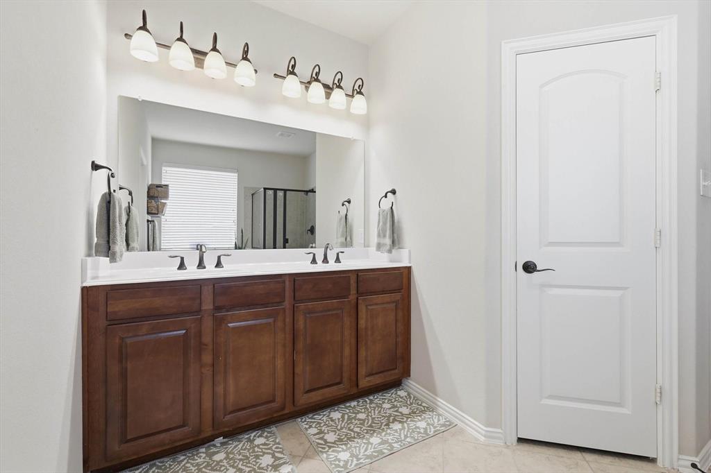 7105 Edwards Road Denton, TX 76208 - Photo 24 of 40 Double vanity with large mirror. Custom closet for exceptional organization.