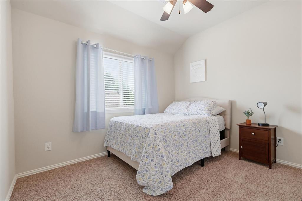 7105 Edwards Road Denton, TX 76208 - Photo 29 of 40 Comfortable secondary bedroom with natural light, ceiling fan and neutral tones.