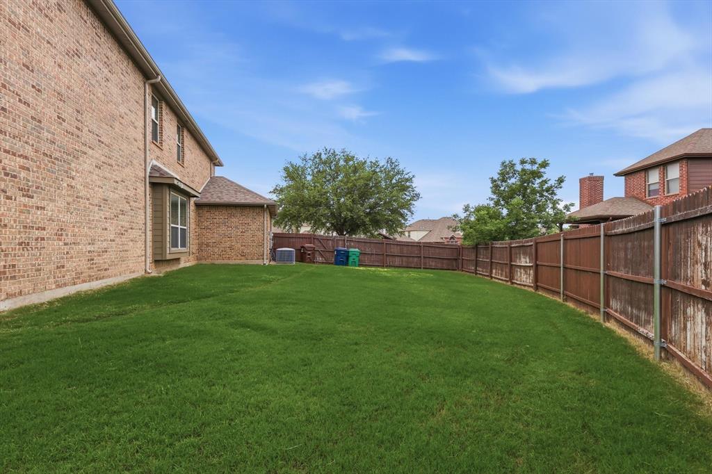 7105 Edwards Road Denton, TX 76208 - Photo 35 of 40 Spacious backyard with full fencing and plenty of room to play or entertain.