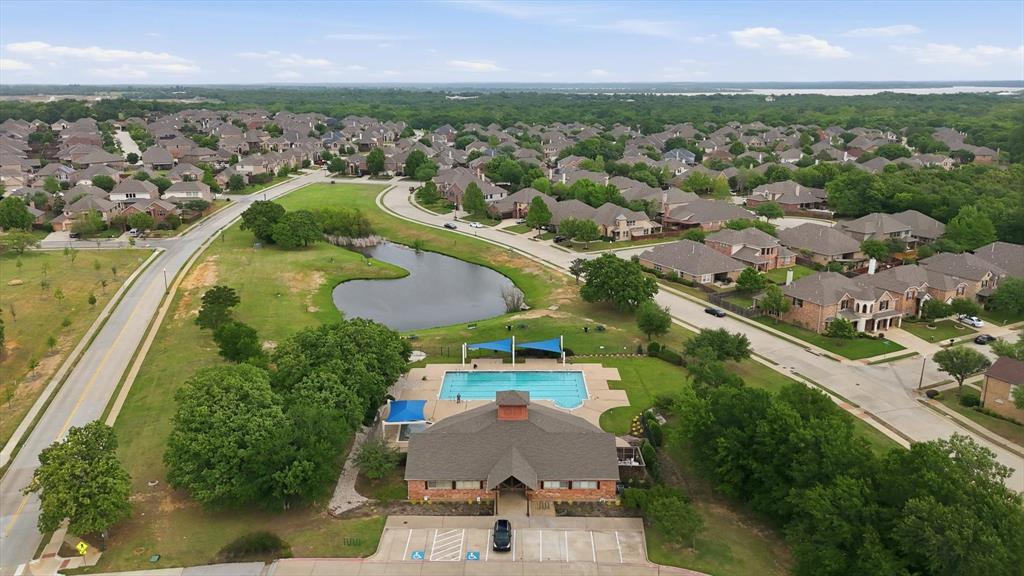 7105 Edwards Road Denton, TX 76208 - Photo 38 of 40 Expansive aerial view highlighting the neighborhood pool, pond, and surrounding green space.