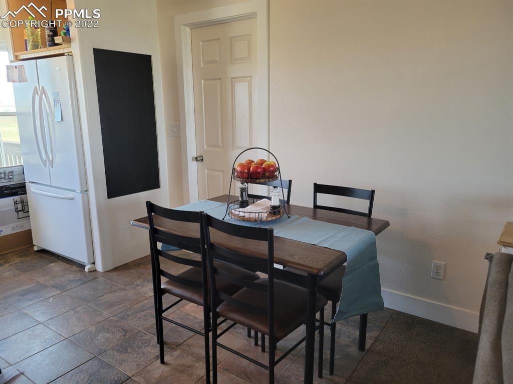 29750 Big Springs Road Calhan, CO 80808 - Photo 2 of 15 a view of a dining room with furniture and wooden floor