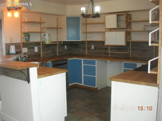 a kitchen that has a sink and a stove