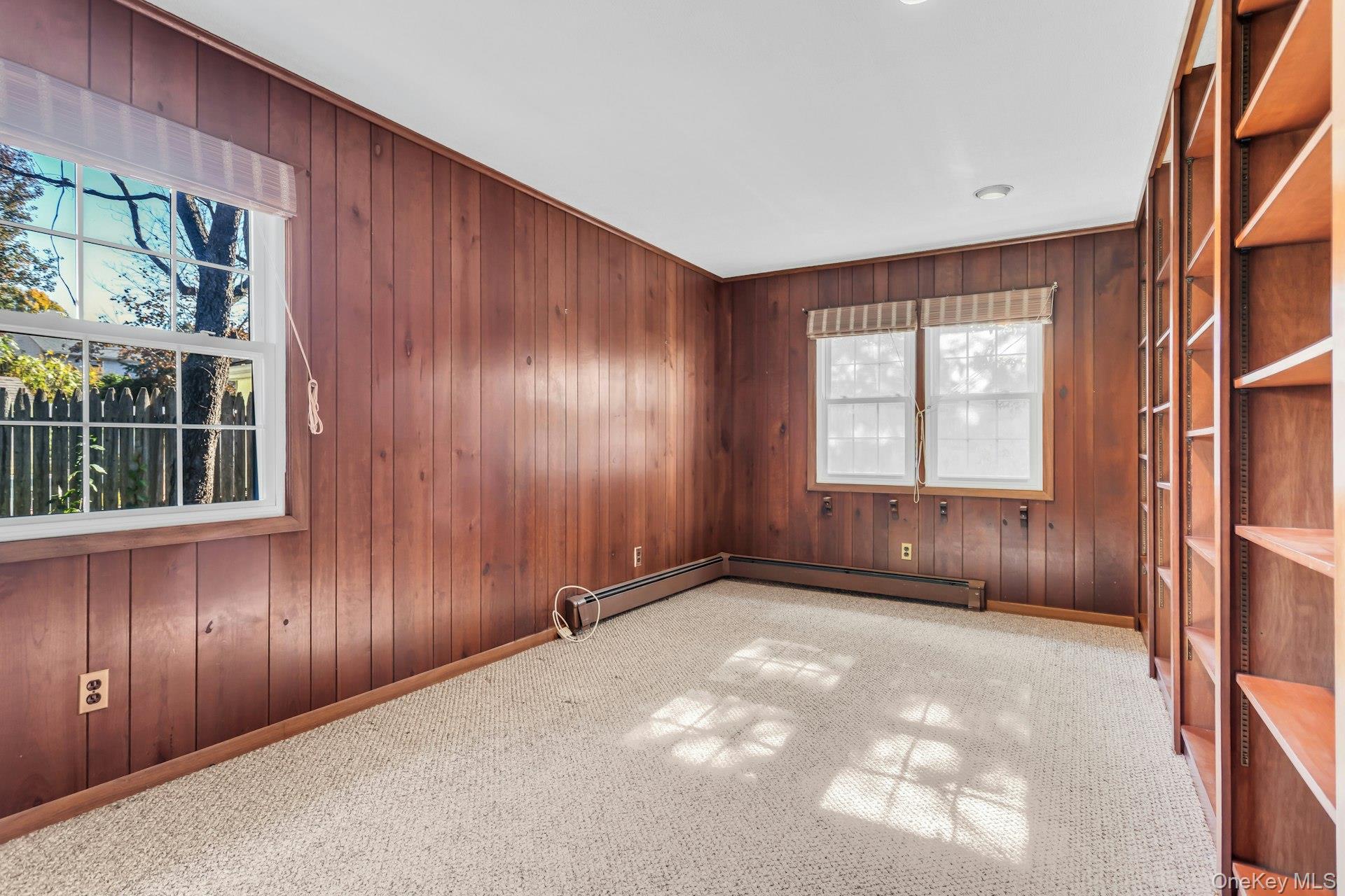 12 Violet Road Bayville, NY 11709 - Photo 17 of 42 Unfurnished room with wood walls, light carpet, and baseboard heating
