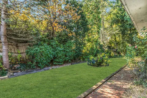 a backyard of a house with table and chairs