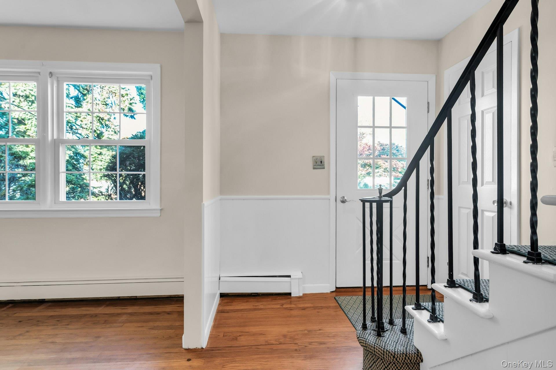 12 Violet Road Bayville, NY 11709 - Photo 3 of 42 Entryway with wood finished floors, a baseboard heating unit, and stairs