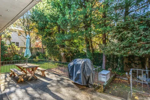 a view of a patio with couches table and chairs and potted plants