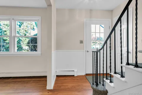 a view of staircase with white walls and a window