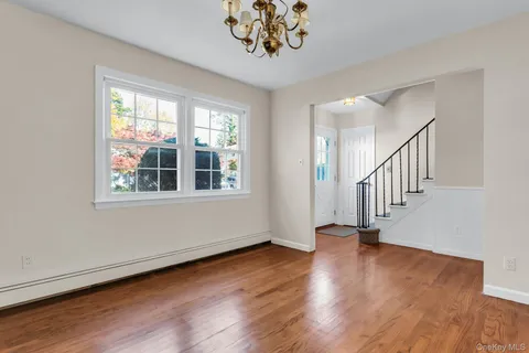 a view of an entryway with wooden floor
