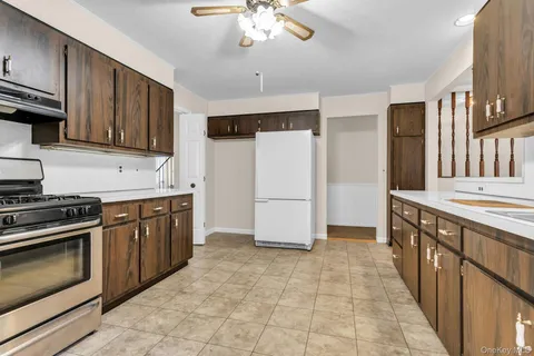 a kitchen with stainless steel appliances granite countertop a stove refrigerator and cabinets