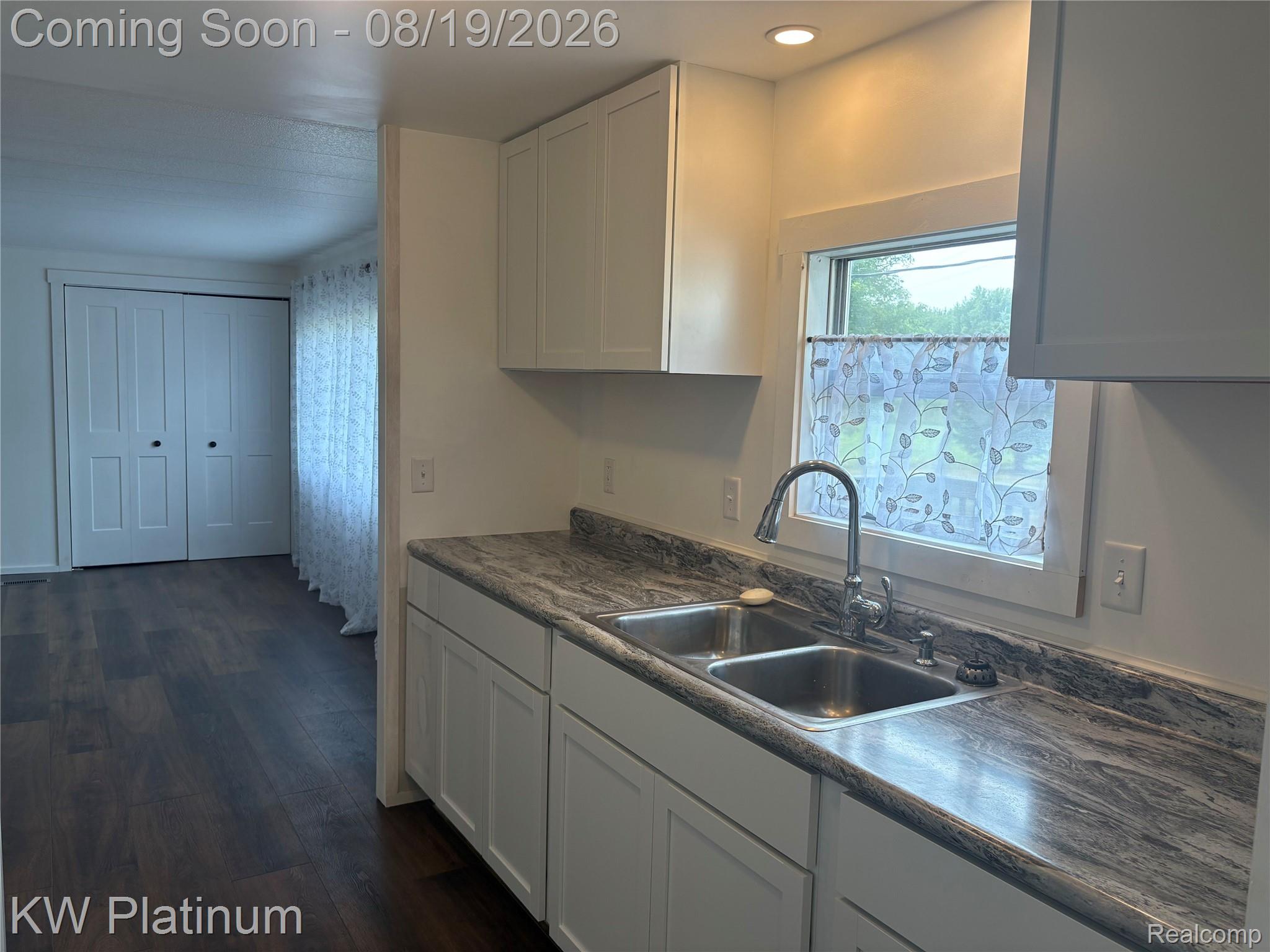 3260 Colclough Road Sandusky, MI 48471 - Photo 9 of 24 White shaker-style cabinetry with a double basin stainless steel sink, pull-down faucet, and patterned countertops