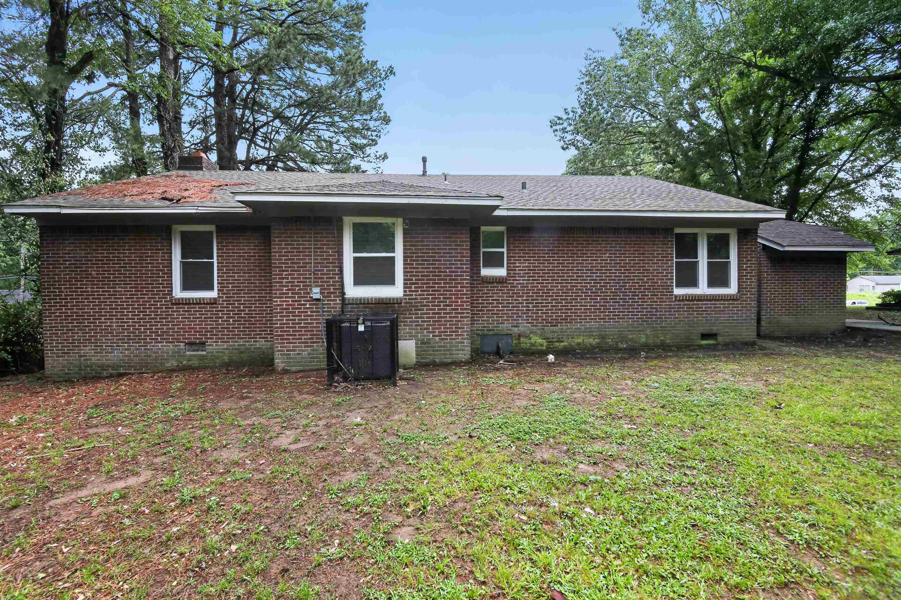 318 East Raines Road Memphis, TN 38109 - Photo 2 of 28 Brick exterior featuring multiple windows and a shingle roof
