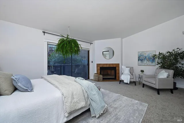 a bedroom with a bed and a fireplace