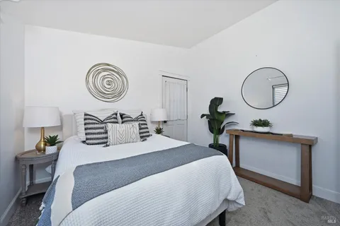 a bedroom with bed and a chandelier