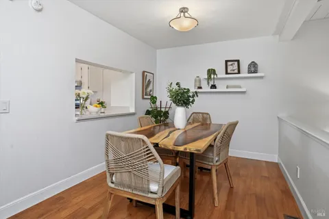 a dining room with furniture and wooden floor