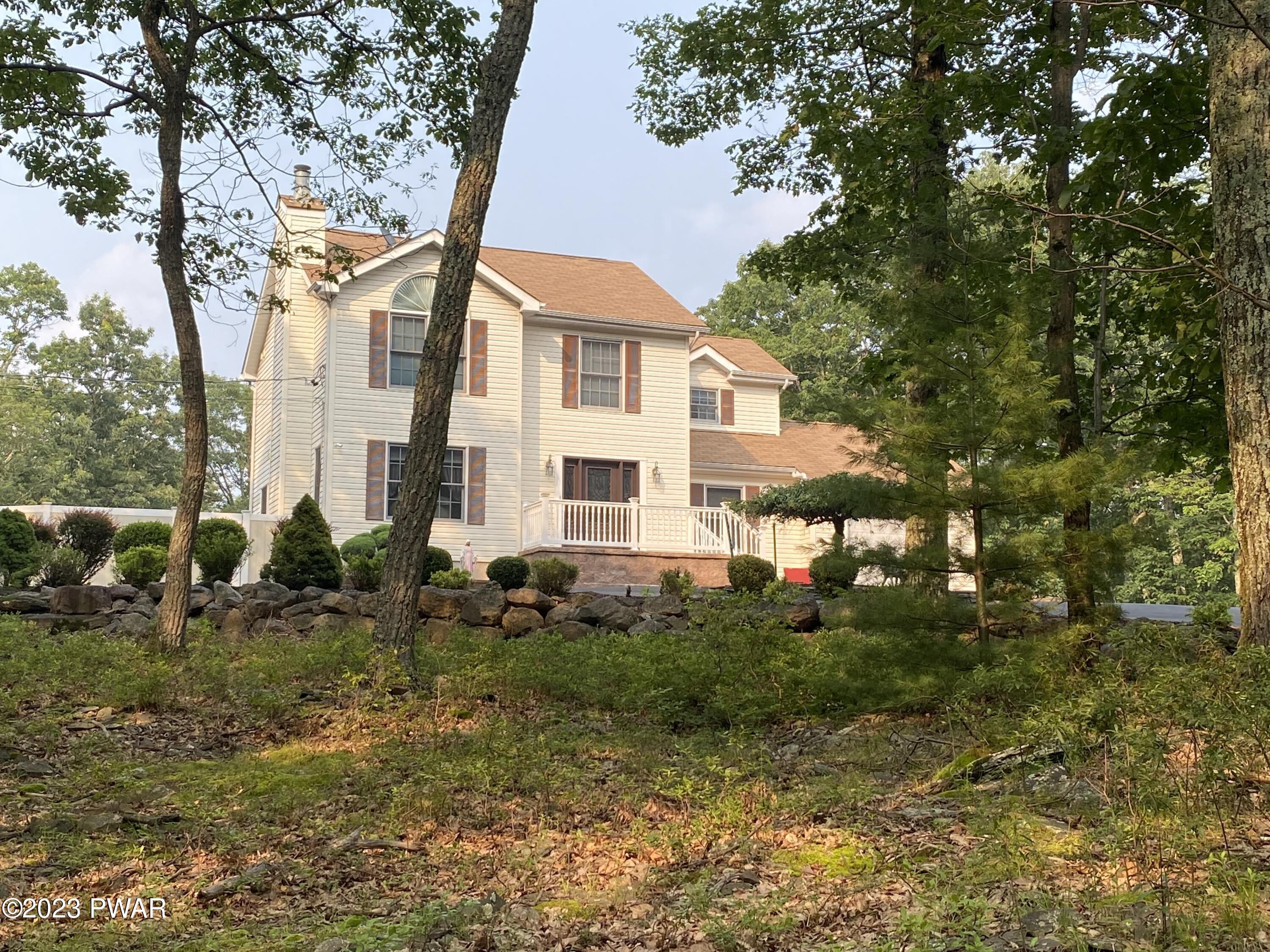 126 Maple Ridge Road Milford, PA 18337 - Photo 2 of 52 a view of a white house next to a yard