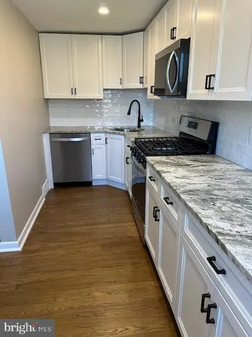 a kitchen with a stove top oven sink and cabinets