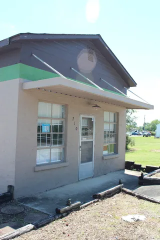 a living room with a bed furniture and a window