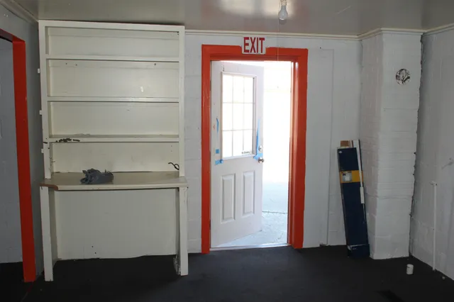 a room with a bench and a window