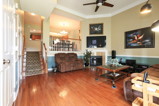 2808 Commons Drive Glenview, IL 60026 - Photo 2 of 14 a living room with furniture a fireplace and a flat screen tv