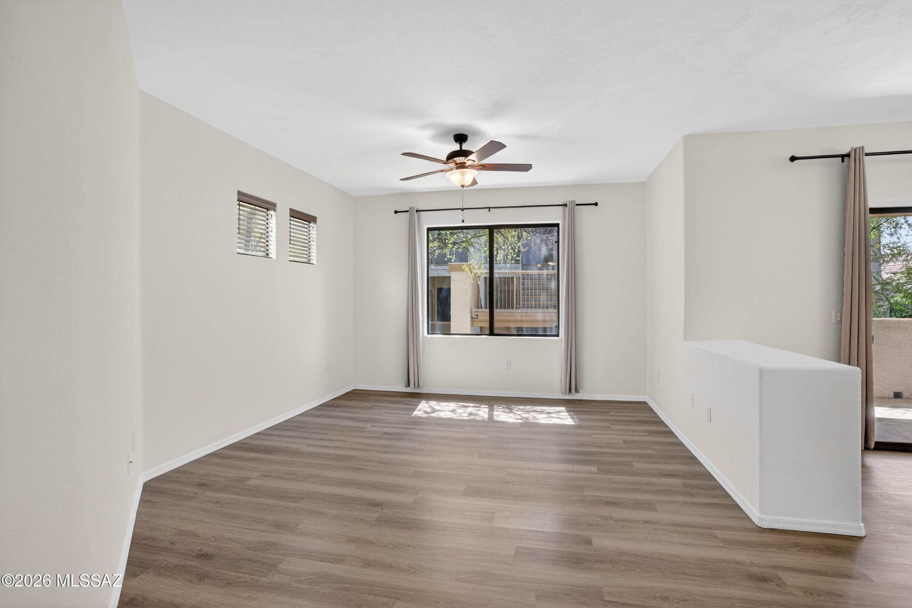 2550 East River Road, Unit 4204 Tucson, AZ 85718 - Photo 5 of 36 a view of an empty room with window and wooden floor