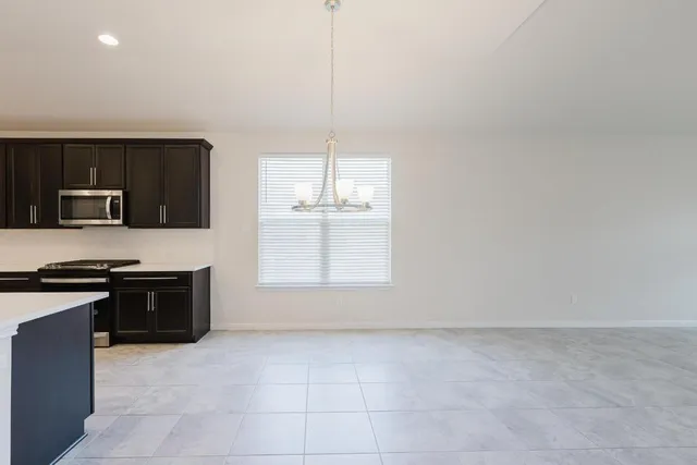 a large kitchen with a stove a sink and dishwasher