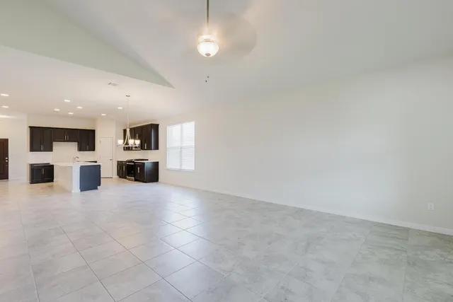 a view of kitchen with stainless steel appliances refrigerator stove microwave and cabinets