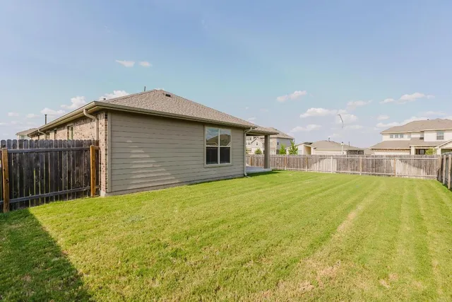 a house view with swimming pool in front of it