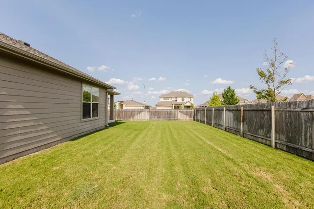 a swimming pool with some trees in the background