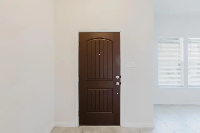 a view of front door with wooden floor