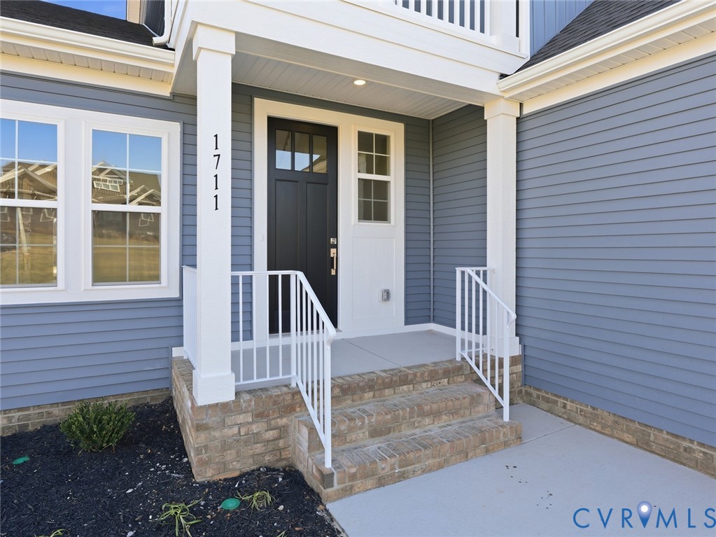 1711 Reed Marsh Lane Goochland, VA 23063 - Photo 2 of 25 a view of a door with a bench and wooden floor