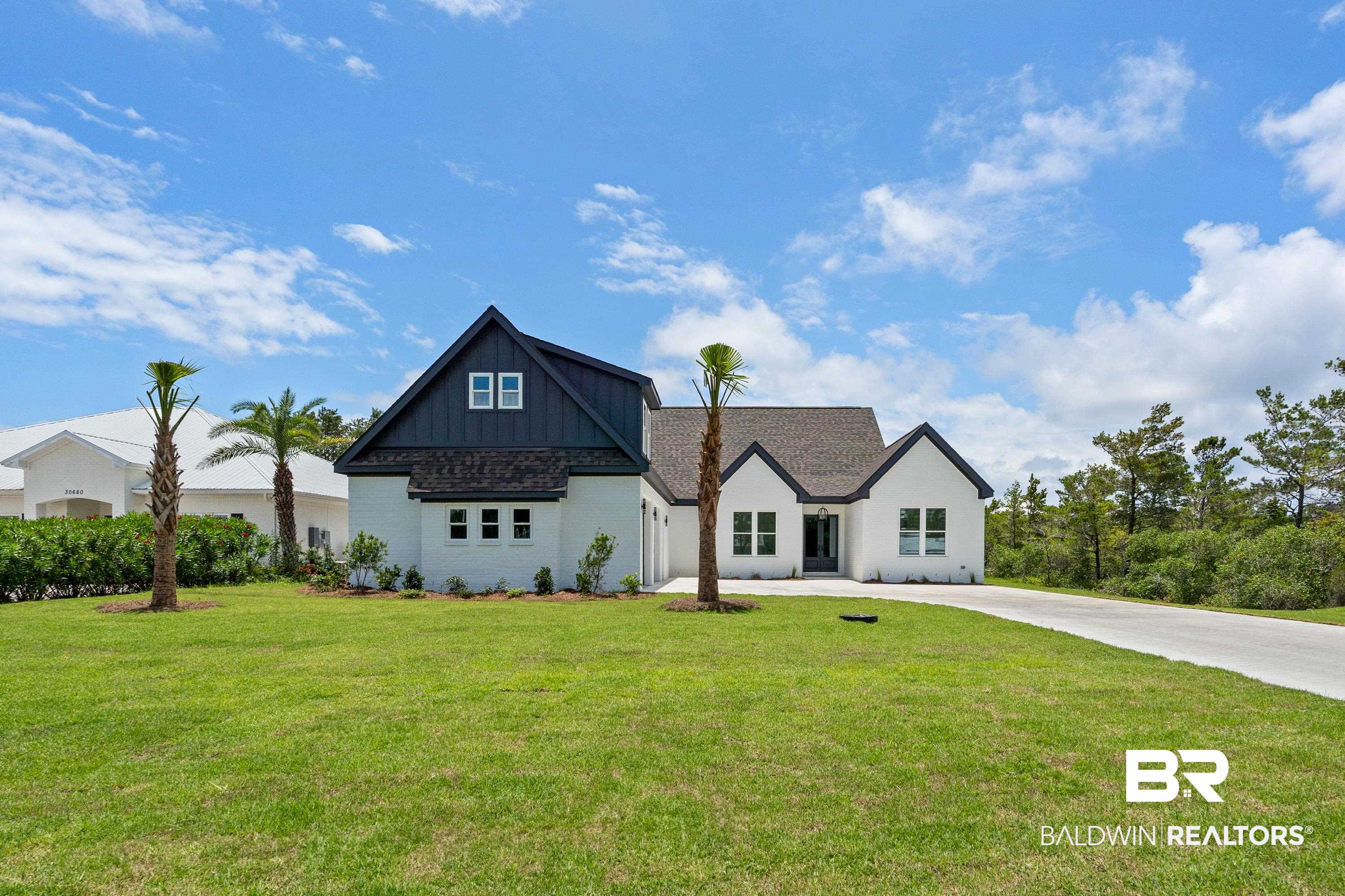 30650 Ono N Loop West Orange Beach, AL 36561 - Photo 37 of 38 Modern farmhouse style home featuring a front yard, driveway, and brick siding
