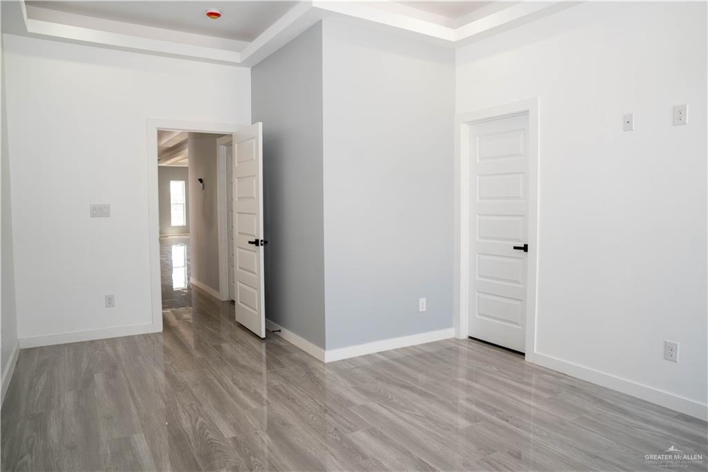 106 West Eldora Road San Juan, TX 78589 - Photo 12 of 29 an empty room with wooden floor and closet