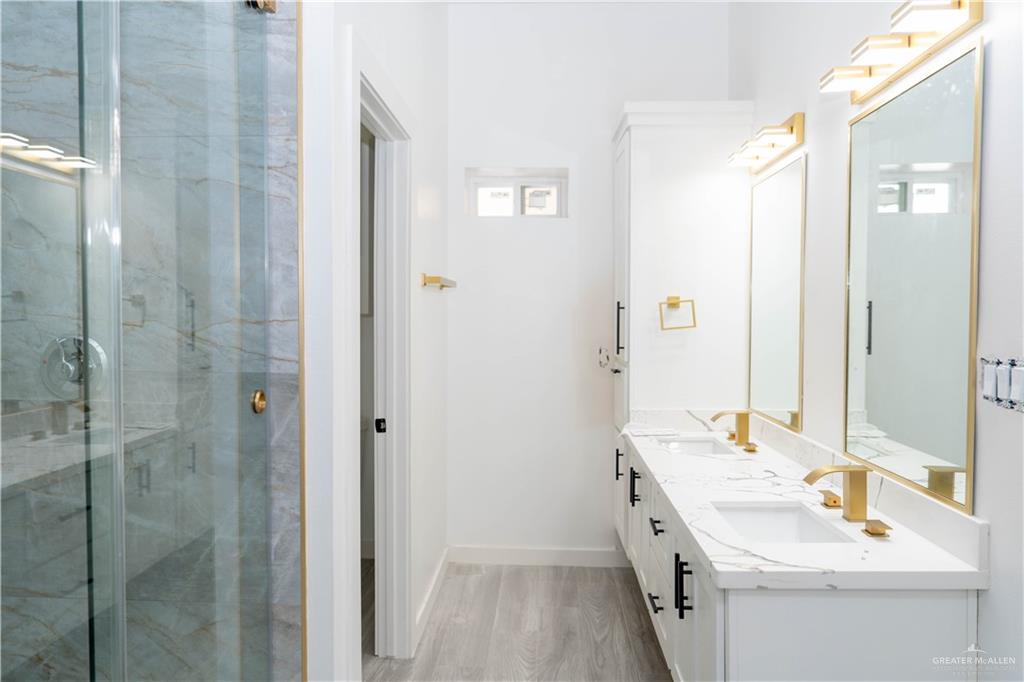 106 West Eldora Road San Juan, TX 78589 - Photo 15 of 29 a bathroom with a double vanity sink mirror and shower