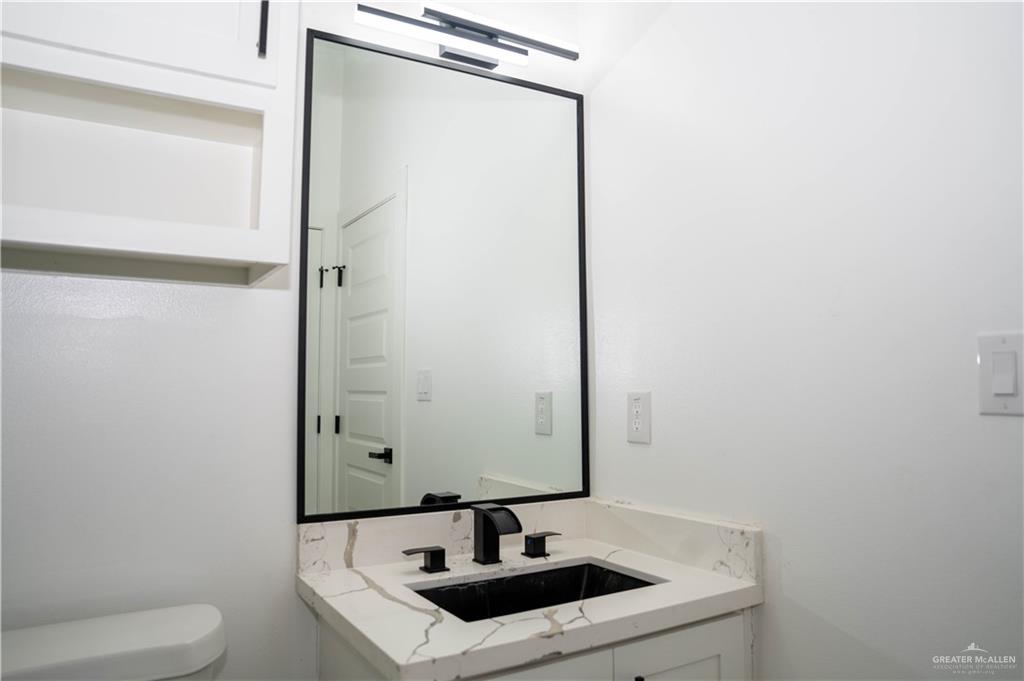 106 West Eldora Road San Juan, TX 78589 - Photo 16 of 29 a bathroom with a sink toilet and mirror