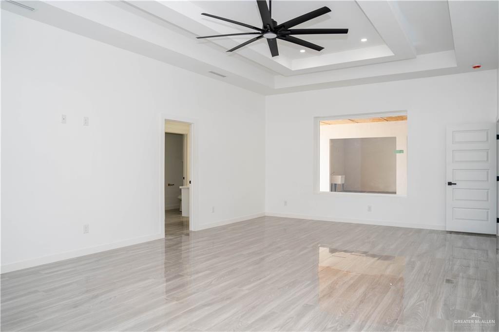 106 West Eldora Road San Juan, TX 78589 - Photo 20 of 29 an empty room with wooden floor closet and windows