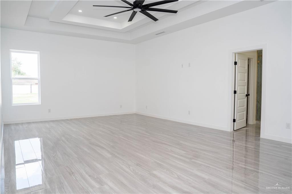 106 West Eldora Road San Juan, TX 78589 - Photo 21 of 29 wooden floor in an empty room with a window