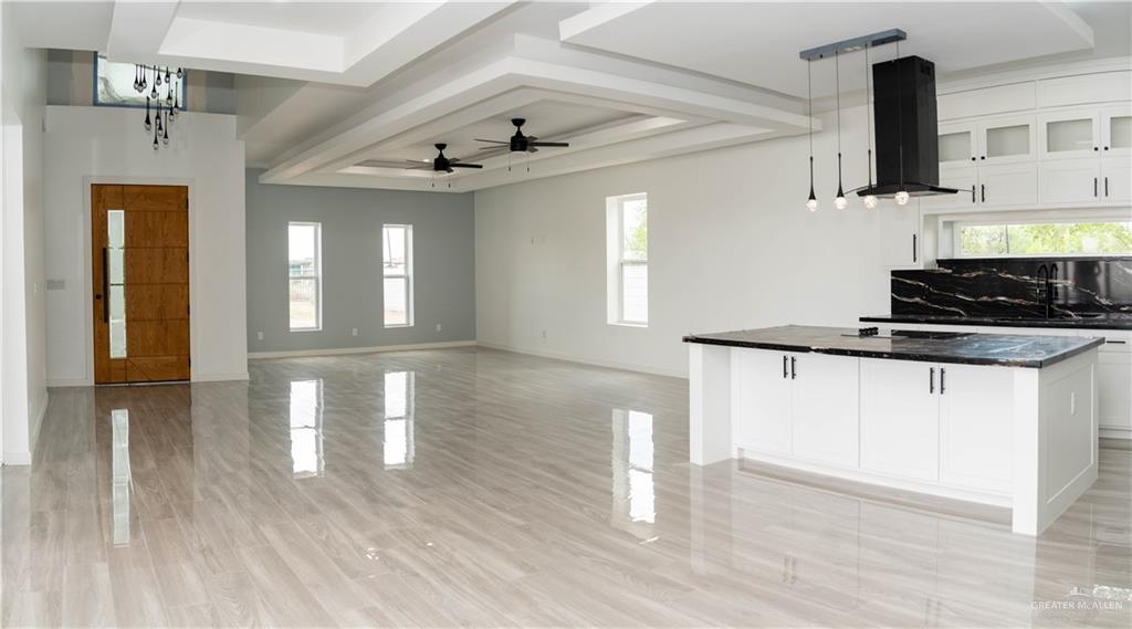 106 West Eldora Road San Juan, TX 78589 - Photo 22 of 29 a kitchen with stainless steel appliances granite countertop a sink dishwasher a stove and white cabinets with wooden floor