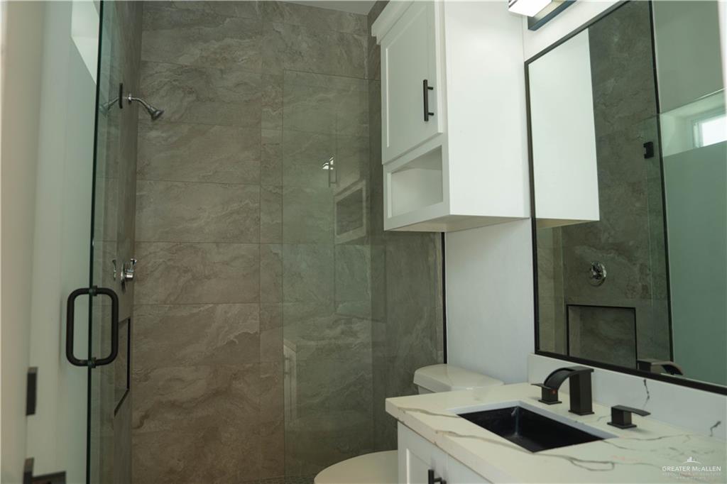106 West Eldora Road San Juan, TX 78589 - Photo 27 of 29 a bathroom with a sink toilet and shower