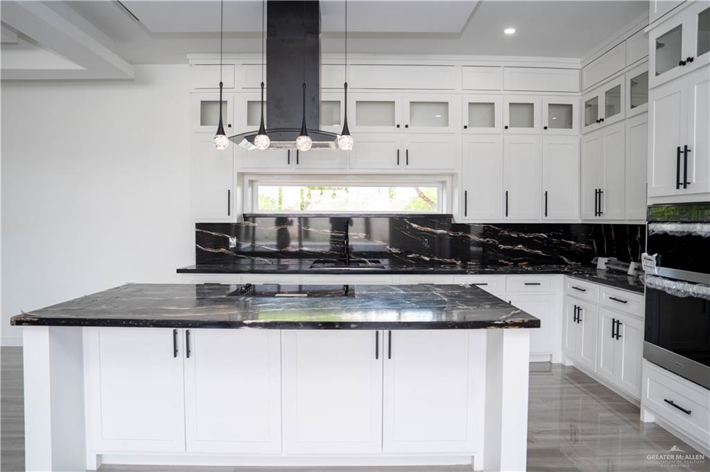106 West Eldora Road San Juan, TX 78589 - Photo 4 of 29 a kitchen with stainless steel appliances granite countertop a sink stove and cabinets