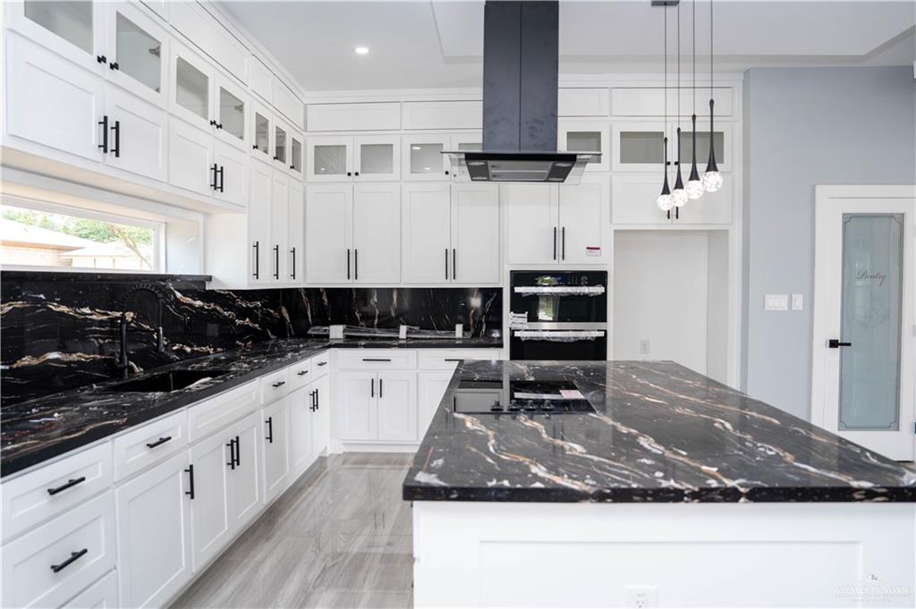 106 West Eldora Road San Juan, TX 78589 - Photo 5 of 29 a kitchen with stainless steel appliances granite countertop a sink and a stove