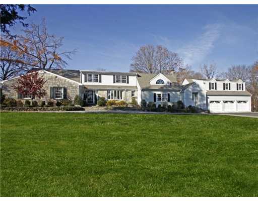 292 Brushy Ridge Road New Canaan, CT 06840 - Photo 1 of 16 a front view of a building with a garden